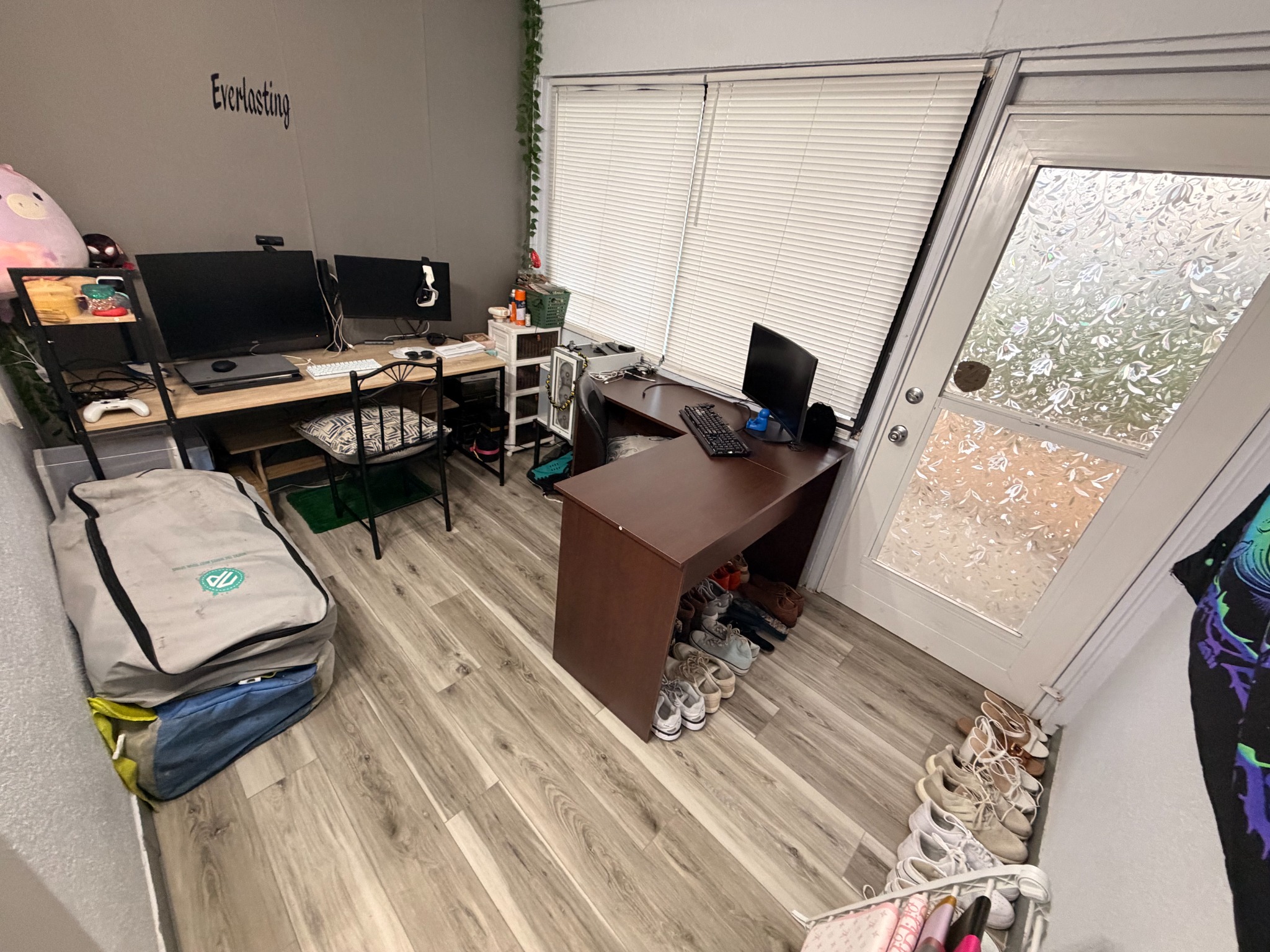 Home office after cleaning and tidying, with clear floor space and organized shoes.