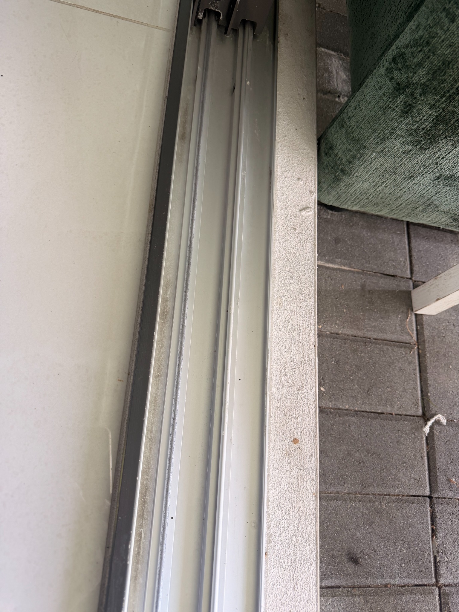Sliding-door track after removal of loose debris and surface dirt.